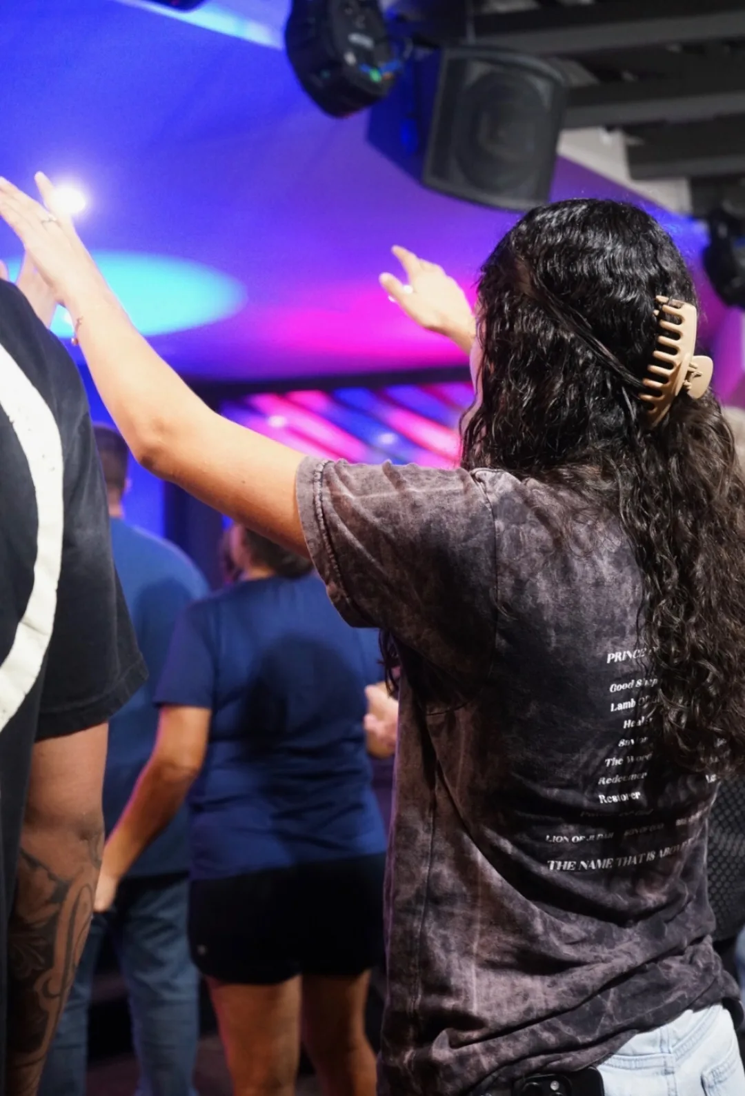 A church member raising her hands during worship