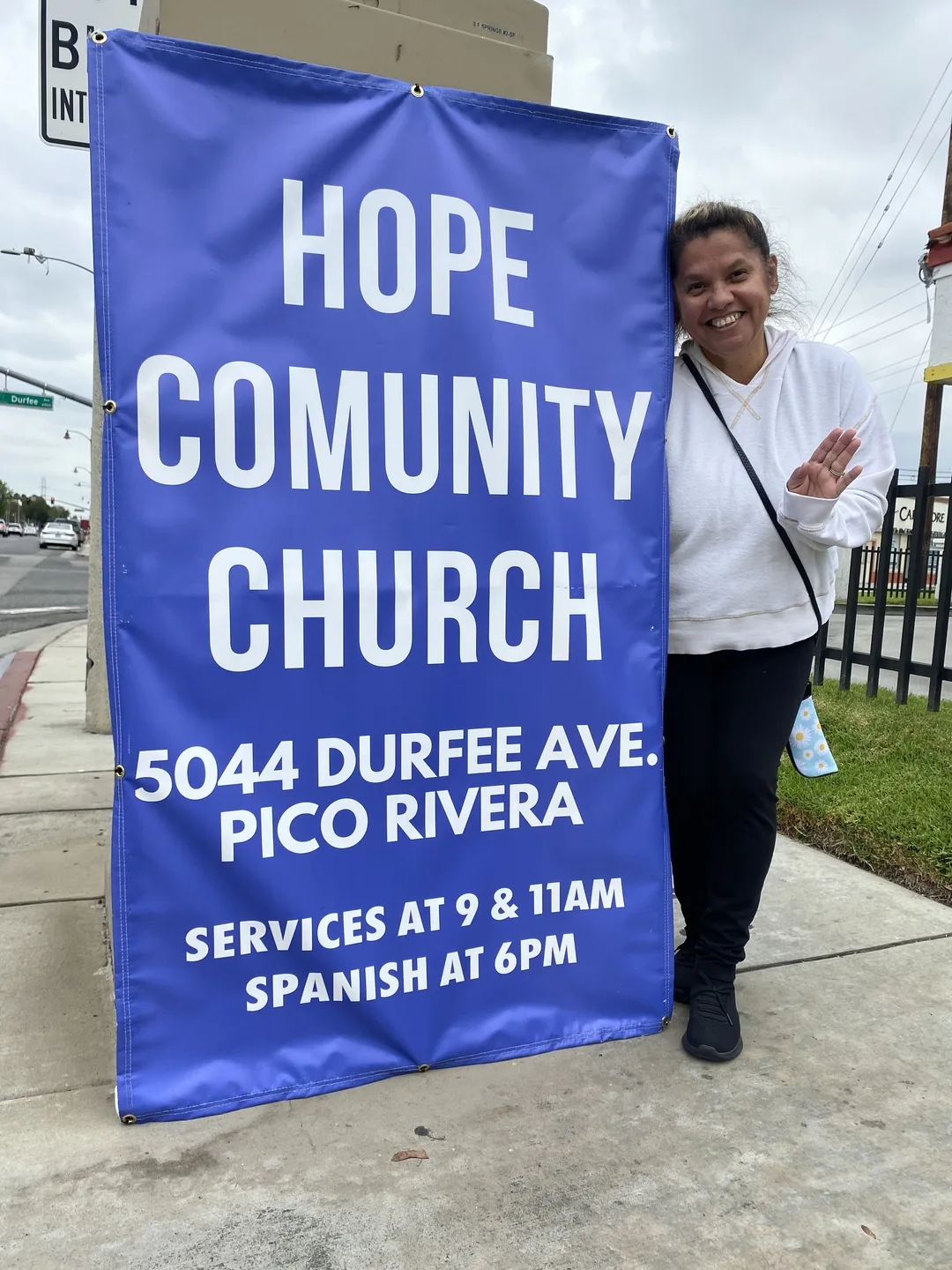 A church member holding a blue Hope Community Church sign